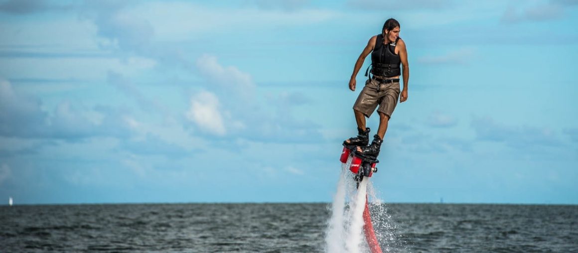 a man flyboarding at sea, miamicurated